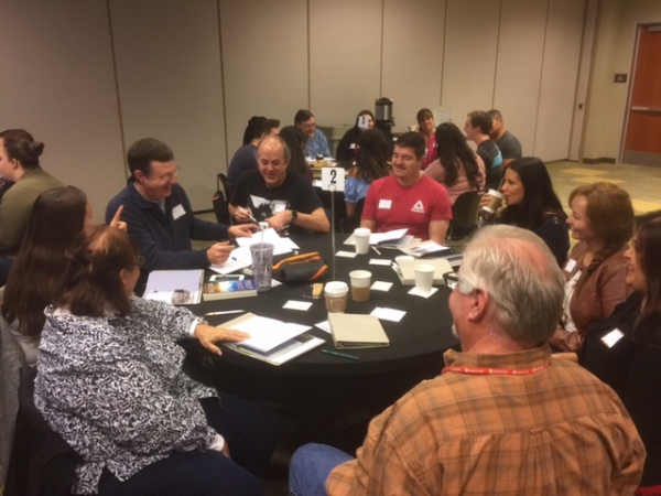 Guests at Next Steps drinking coffee and playing the Get to Know Each Other Game with dice. This is very similar to the opening questions shared when a small group is new. It gives them a taste of community that many times leaves them open or even wanting more.