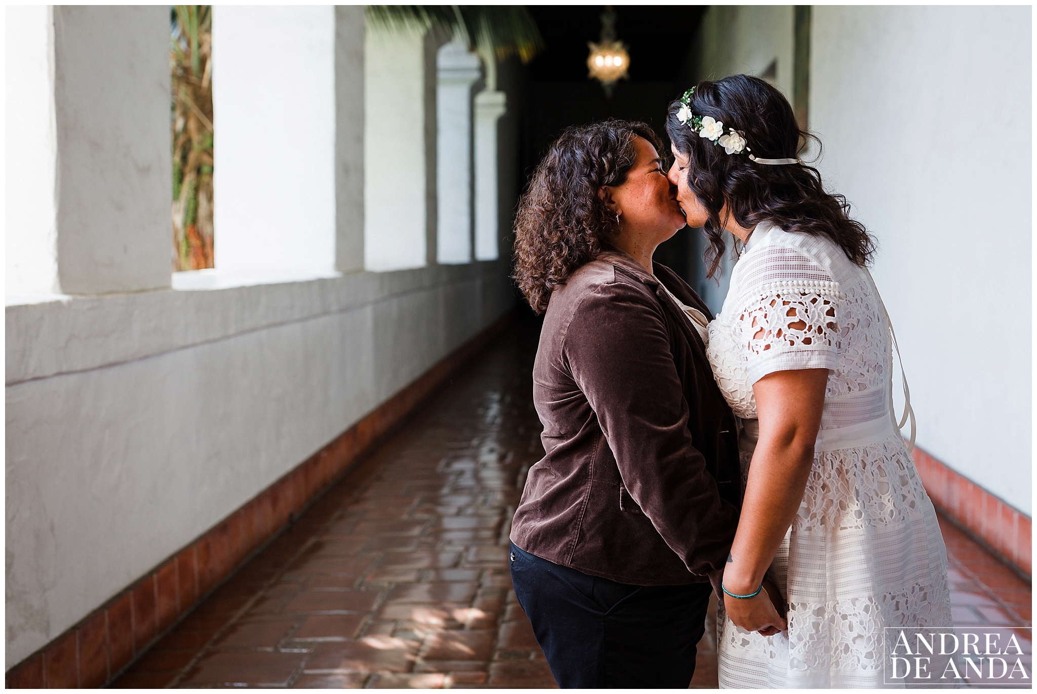 The brides sharing a romantic moment in one of the Santa Barbara Courthouse grand open hallway filled with natural light and romance. 