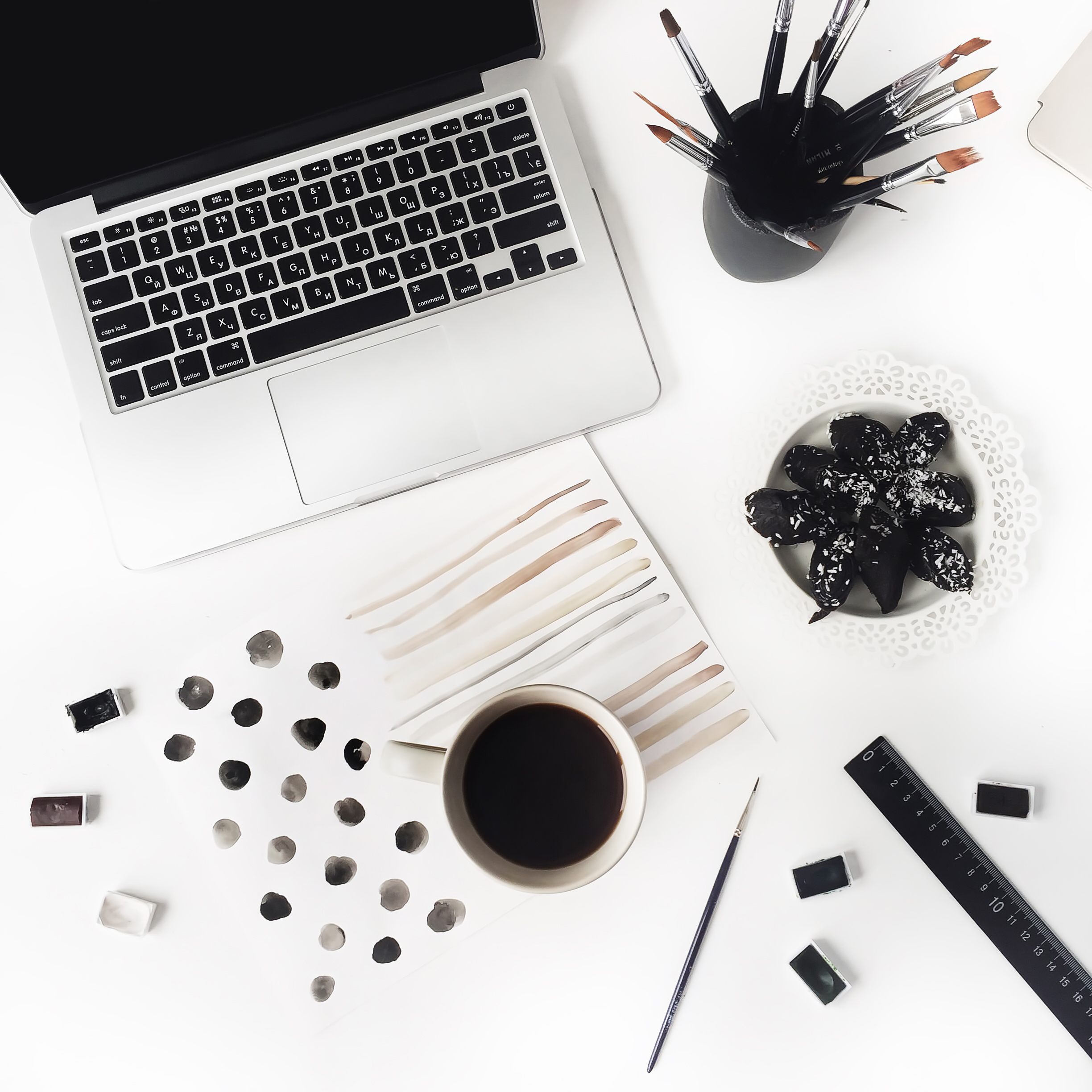  Working place with laptop, cup of coffee and watercolor paintings 