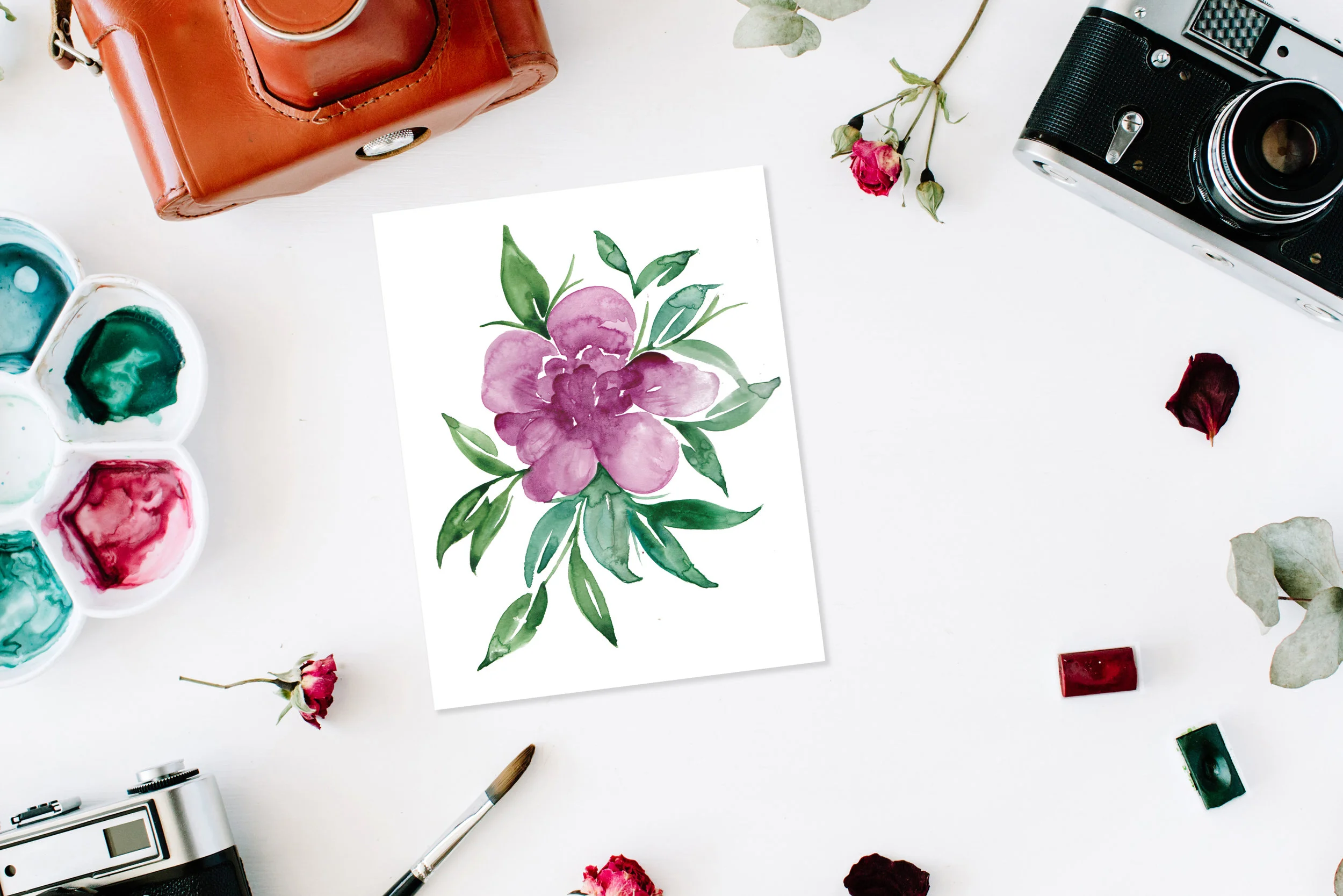  Flat lay. Artist workspace frame with vintage retro photo camera, and watercolor, red roses and eucalyptus. Top view arrangement 