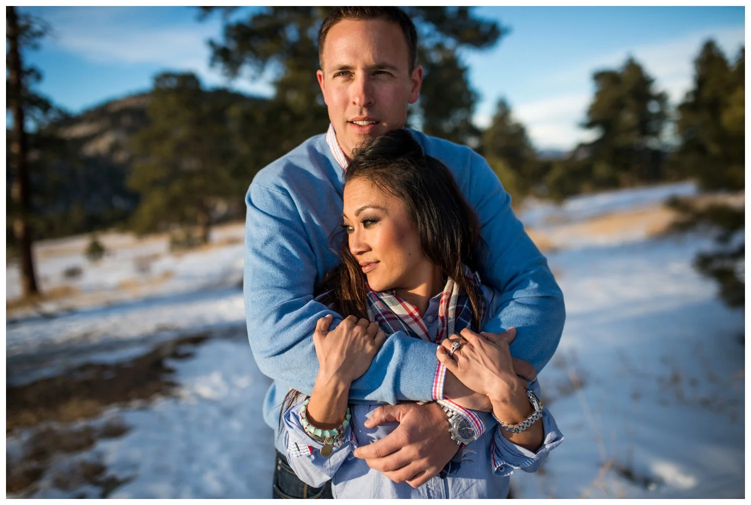 couple hug in sunny winter Colorado engagement photo