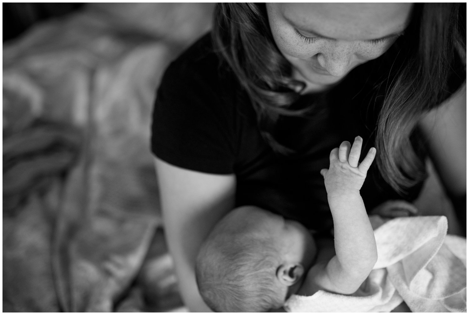 lifestyle newborn photography of baby hand and mother