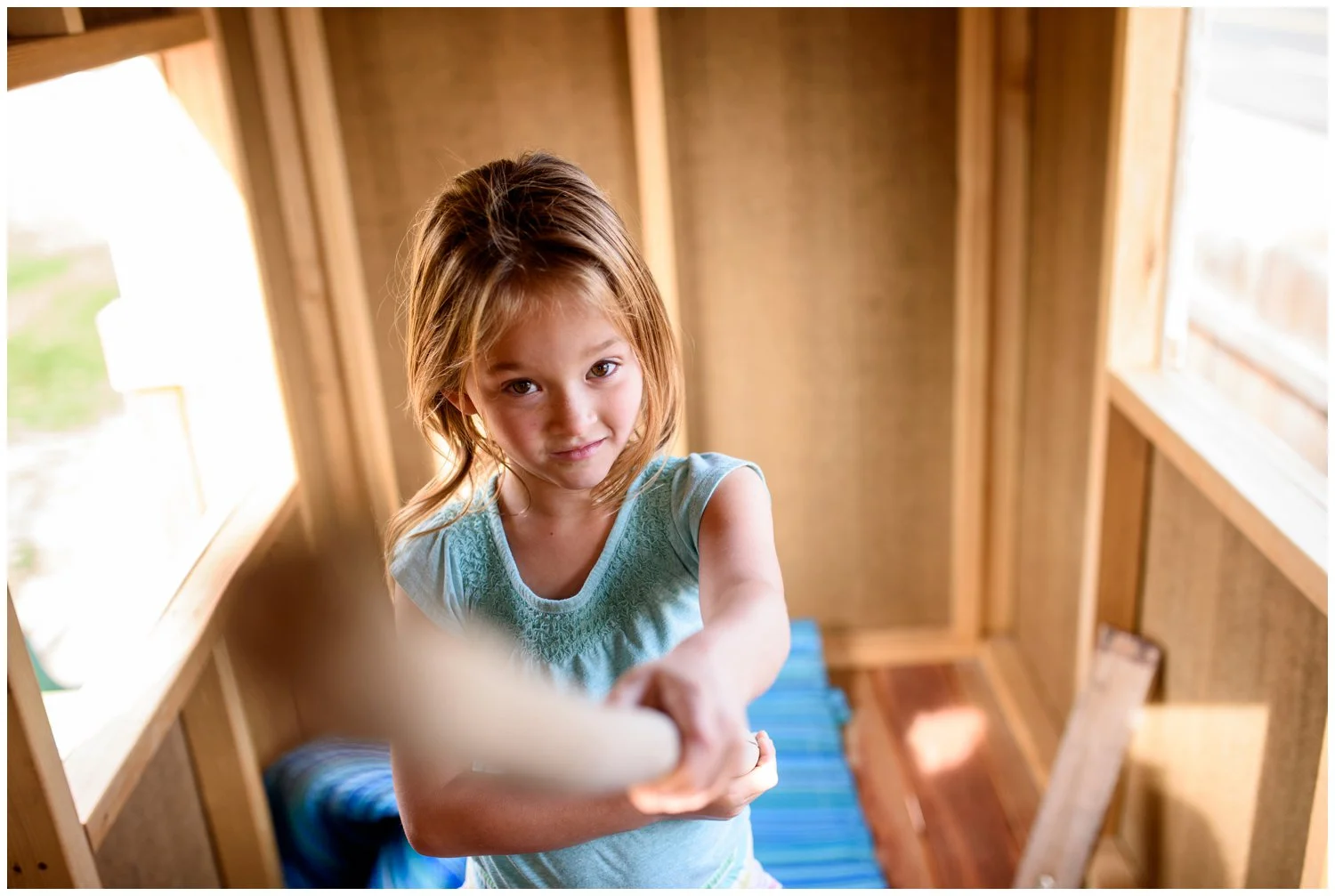 denver area candid family photo of girl playing in treehouse