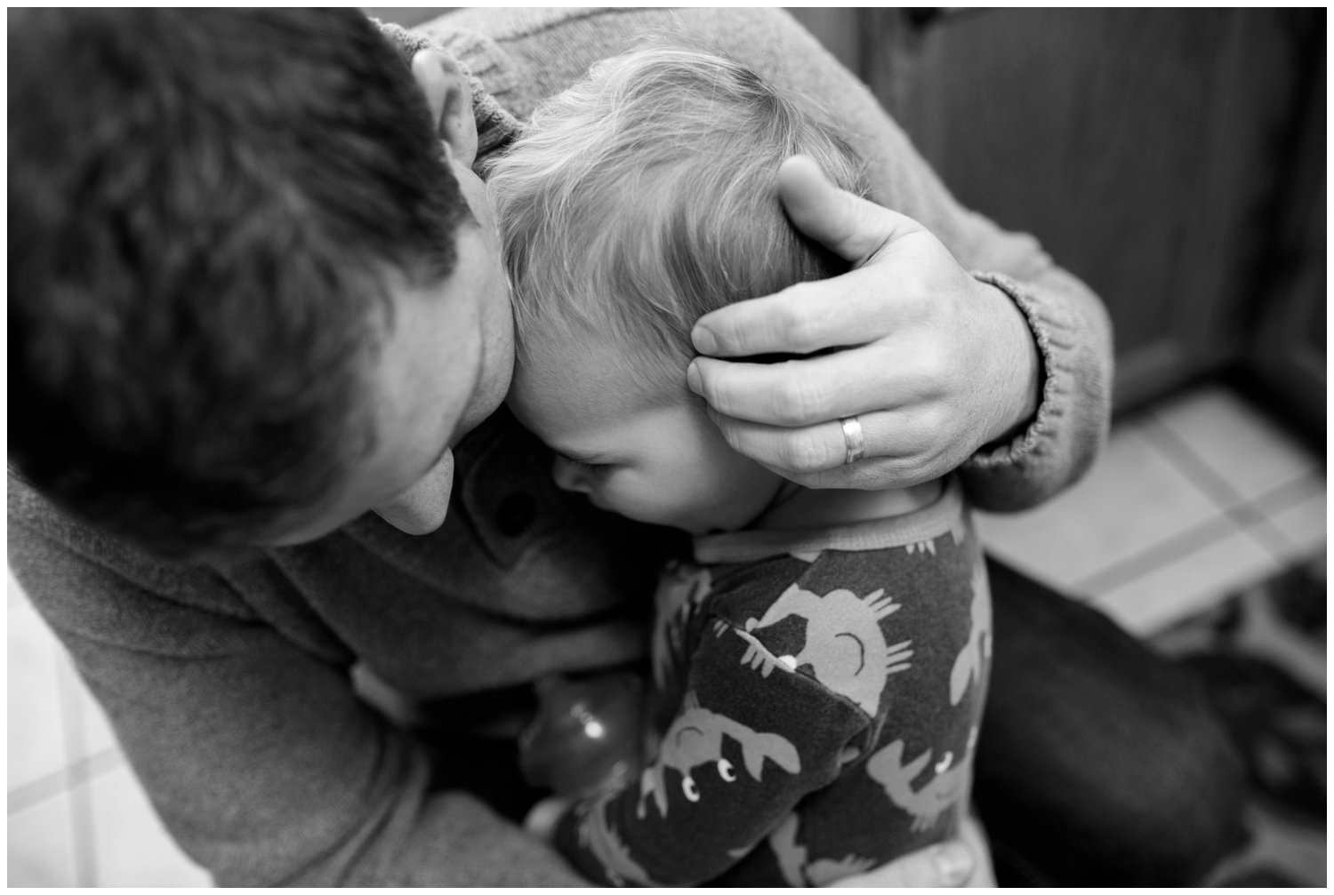 father hugs son black and white photo