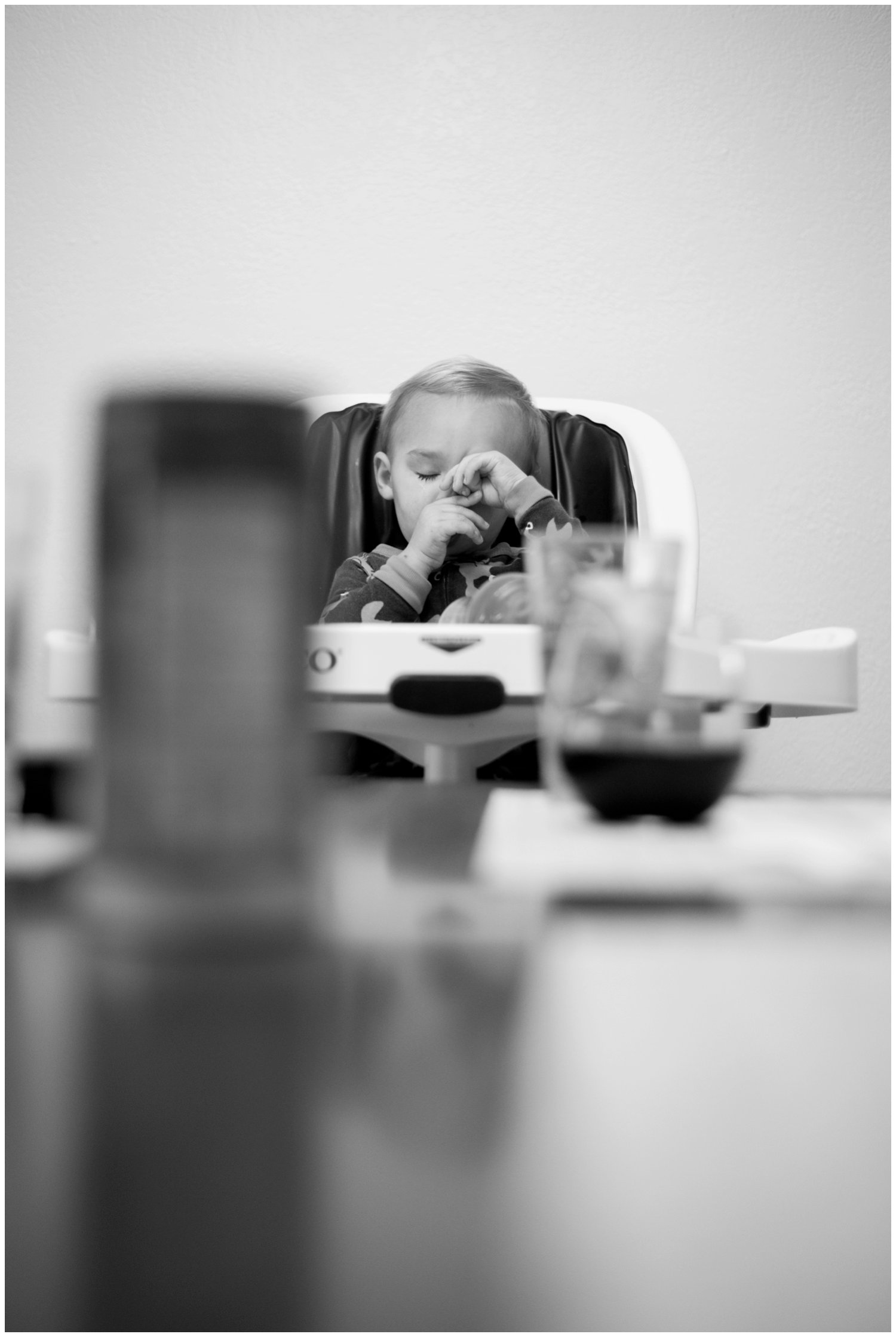 toddler sucks thumb in photojournalistic family photo