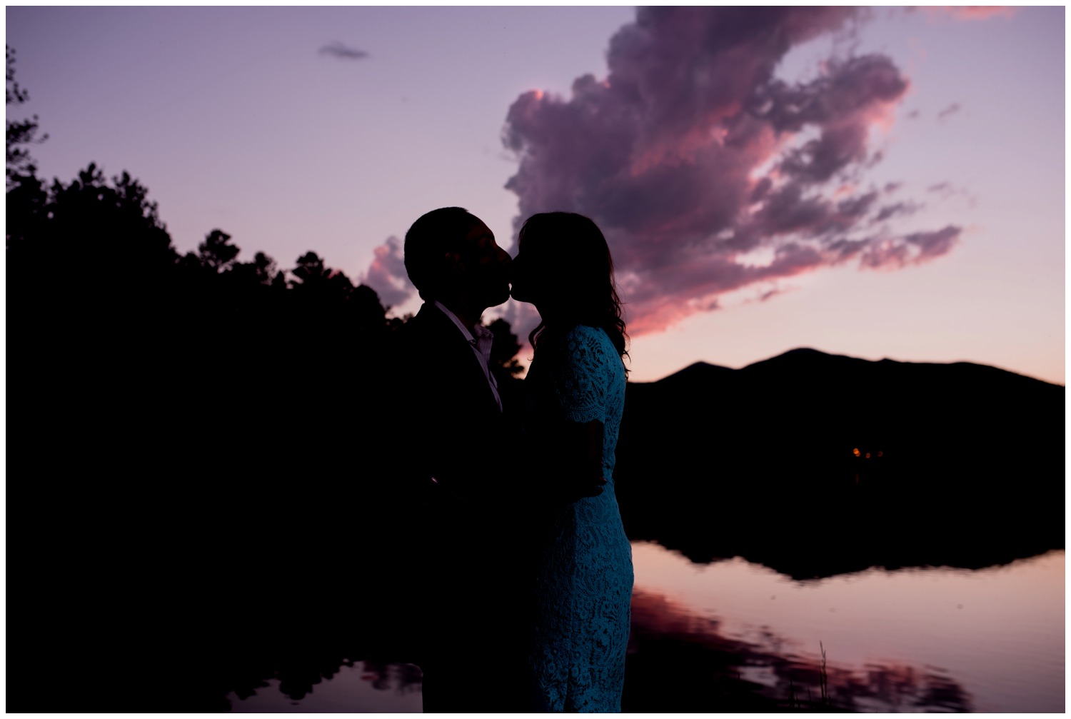 purple sunset engagement photo on lake