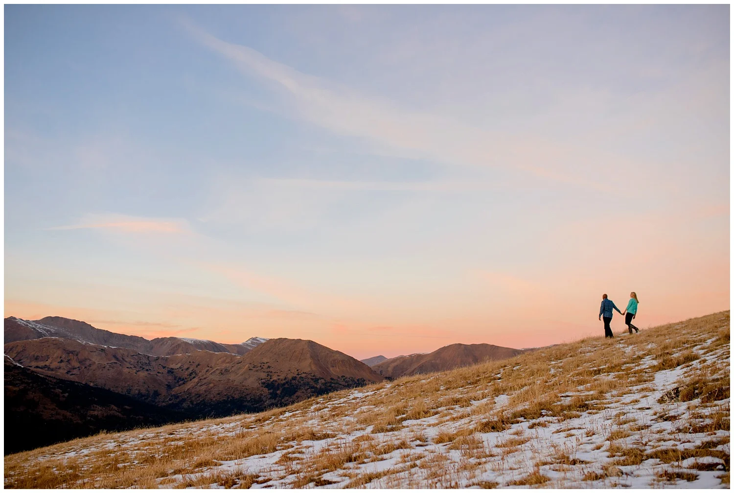 couple walks on Loveland Pass at Sunset