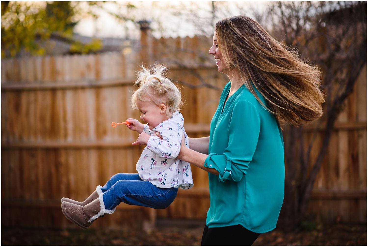 mom and daughter twirl in colorado family photo