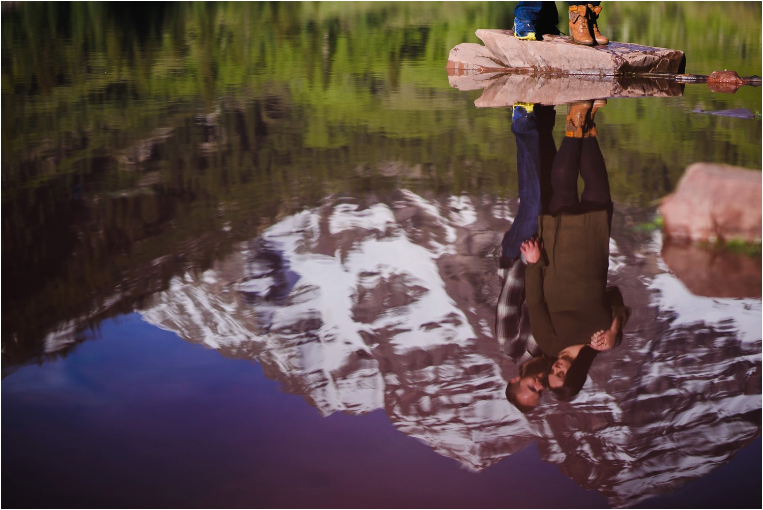engaged couple reflected in Maroon Lake