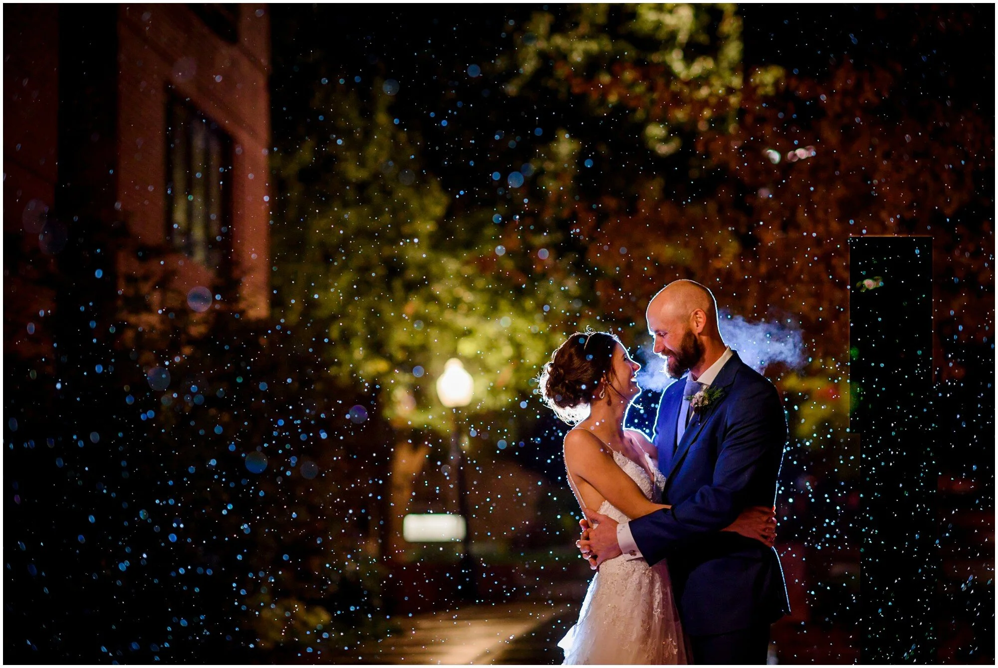 Wedding couple embraces in the snow after their wedding in Boulder, Colorado