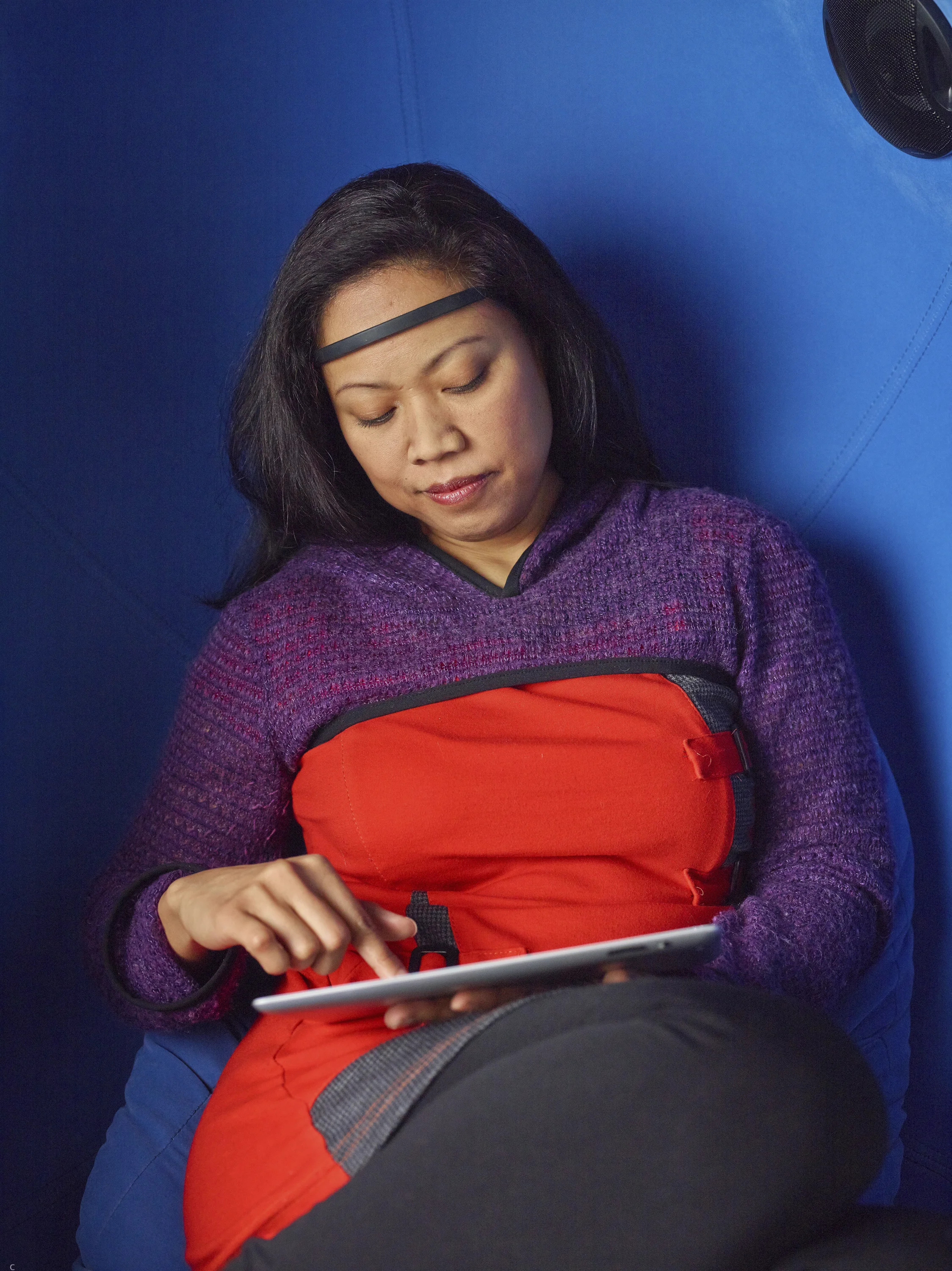 81-Woman reviewing her data in egg chair.jpg