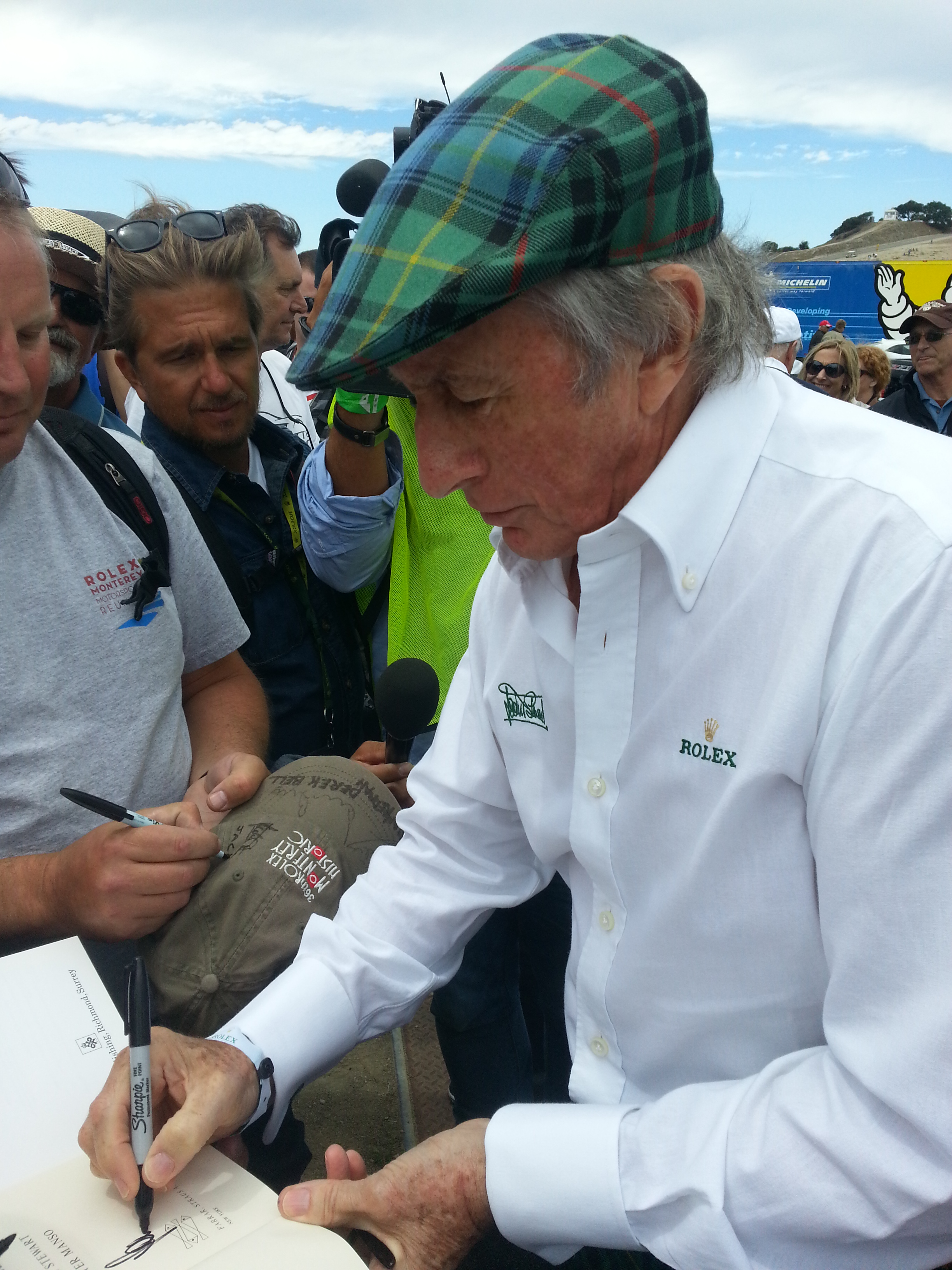 Sir Jackie Stewart signs autographs