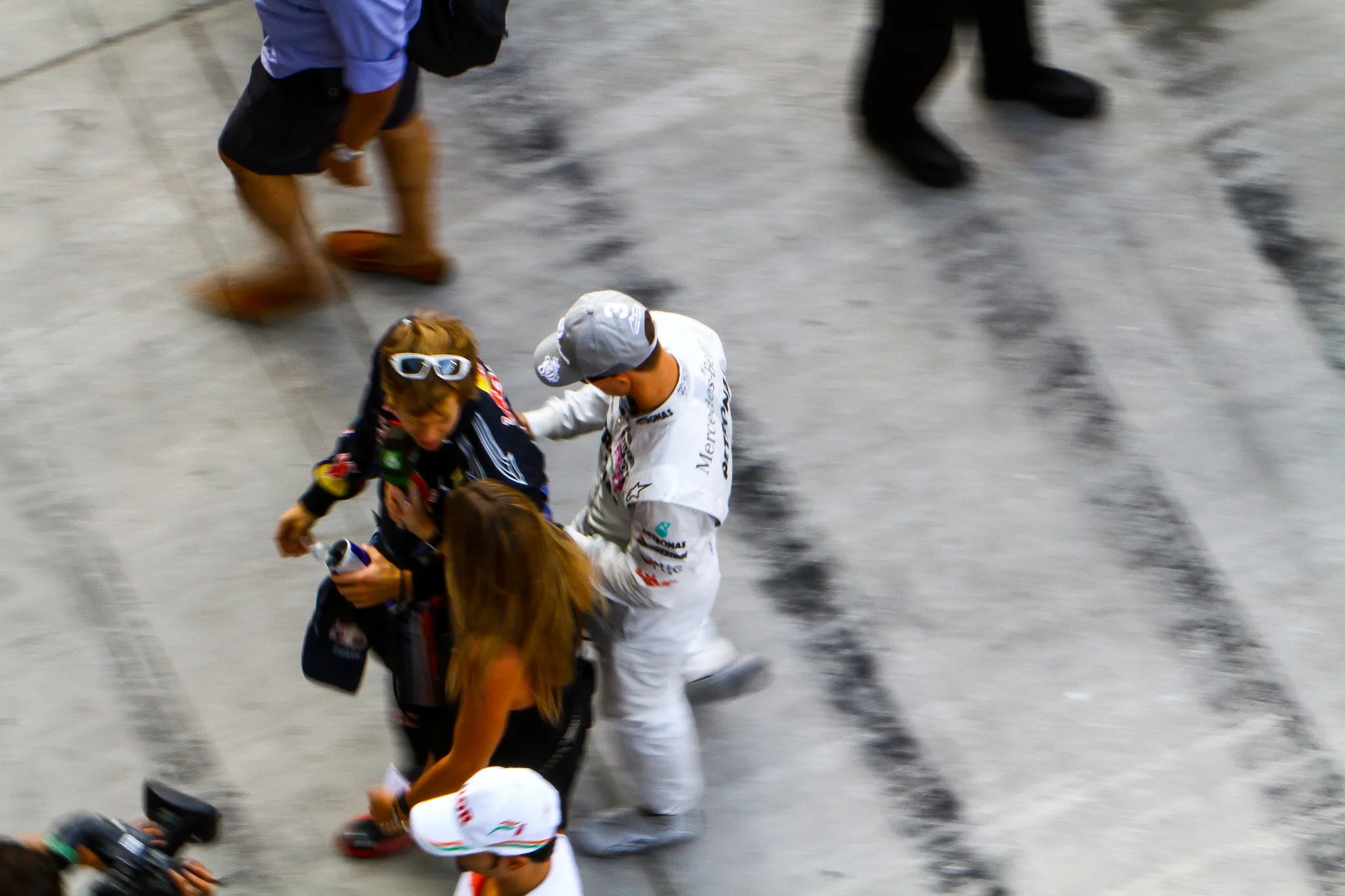 During the pre-grid at the 2010 Formula 1 Abu Dhabi Grand Prix. Schumacher plays a prank on a young Vettel prior to the race. Right after this moment they exchanged greetings and talked for a minute. Vettel would claim his first world title when the race was over. Copyright: Mark Farouk, The Loud Pedal