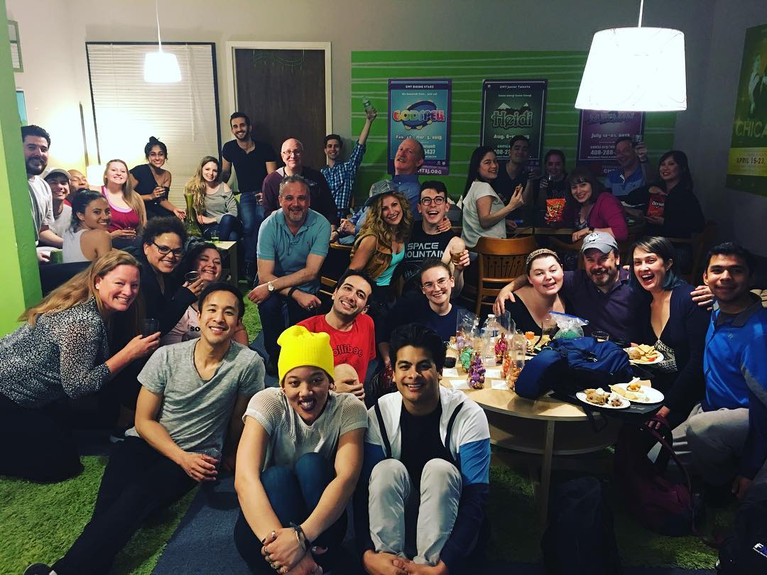 The cast takes a breather after a late-night Friday rehearsal.