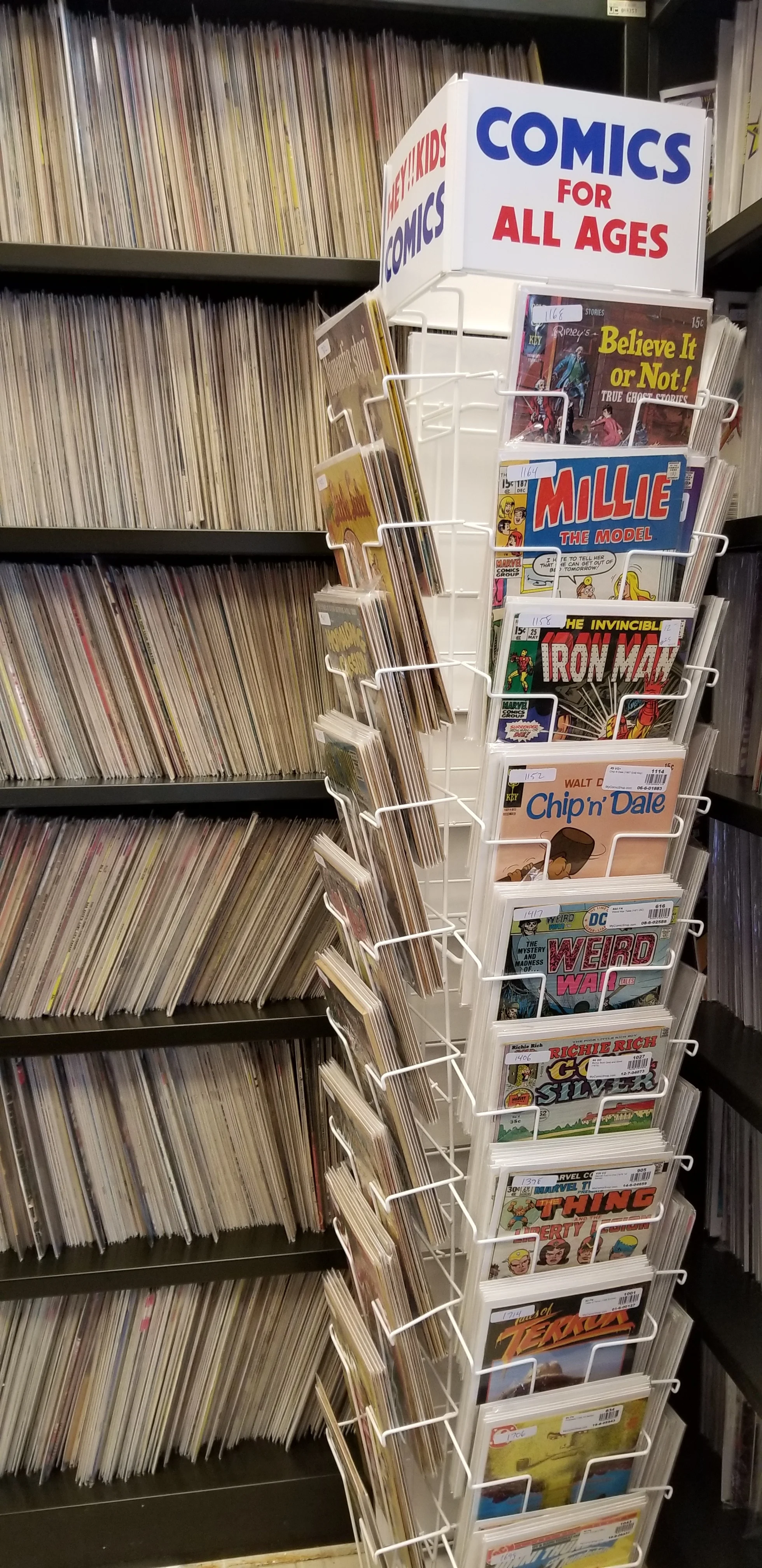 Ugly industrial shelving, wonderful spinner rack, so many comic books.