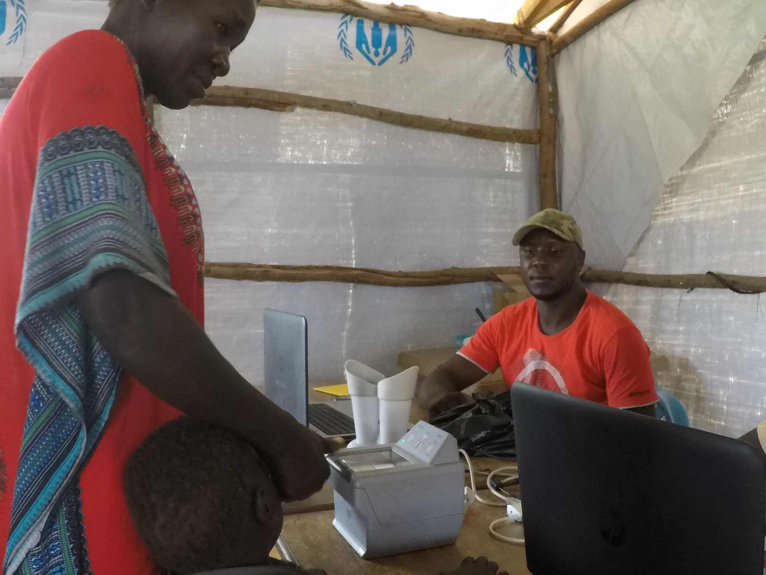 Biometric screening at the collection point to see if someone has already been registered as a refugee.