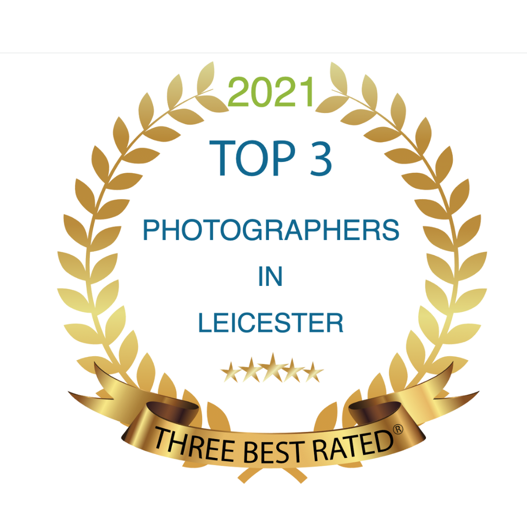 Award badge with gold laurel wreath, text stating '2021 Top 3 Photographers in Leicester,' five stars below, and a gold ribbon at the bottom reading 'Three Best Rated'.