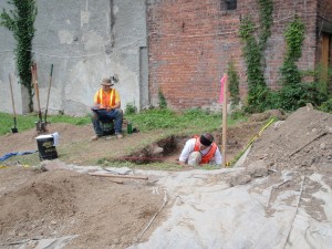 Archaeologists recording soil stratigraphy and measuring depths at 15 Alexander Street.