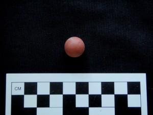 A red clay marble from 70 Broad Street.