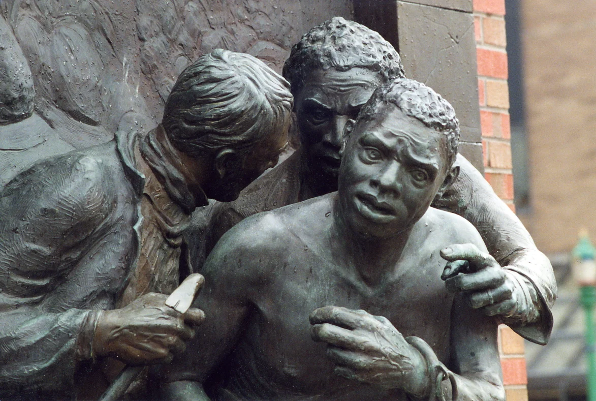 The bronze statues depict William "Jerry" Henry fleeing with abolitionist supporters.