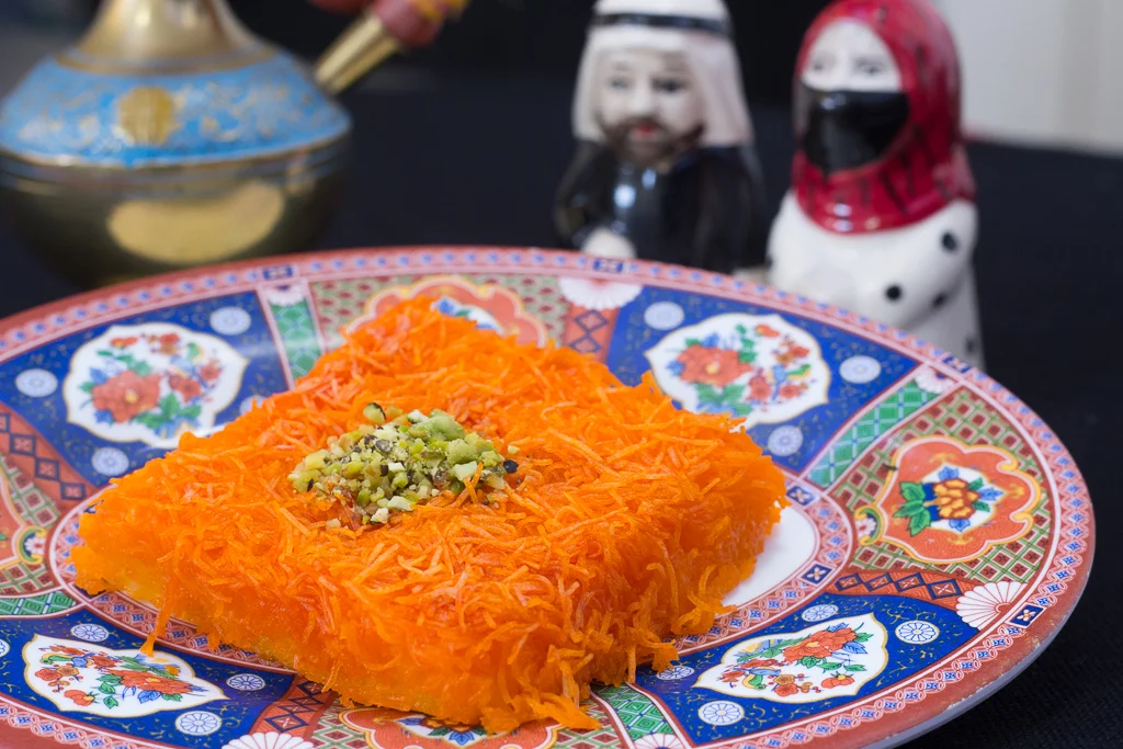 Knafeh Biljibneh - layers of semi-sweet cheese baked and topped with cane syrup, and pistachios