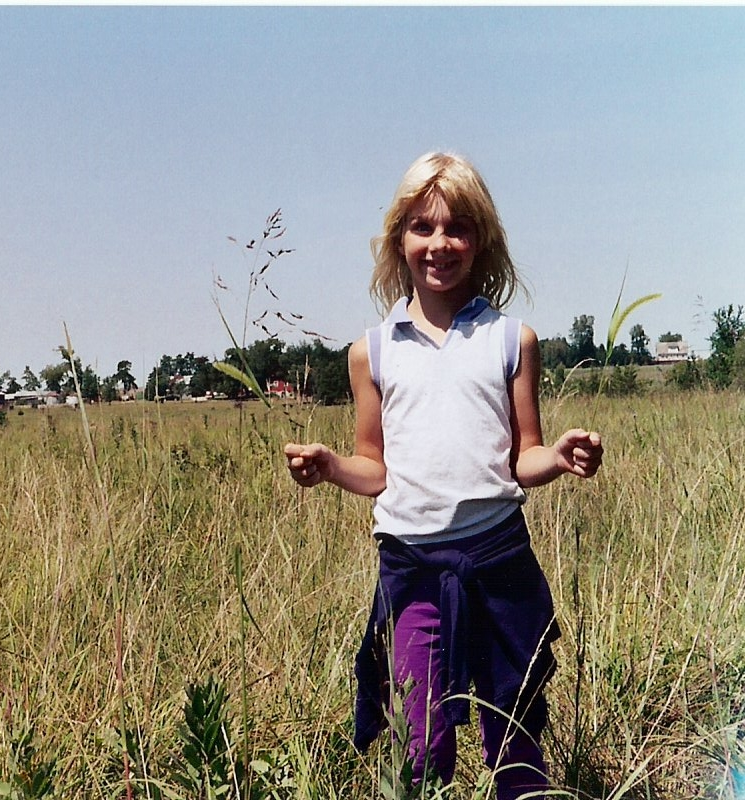 A younger me, demonstrating what grass looks like in one of our pastures