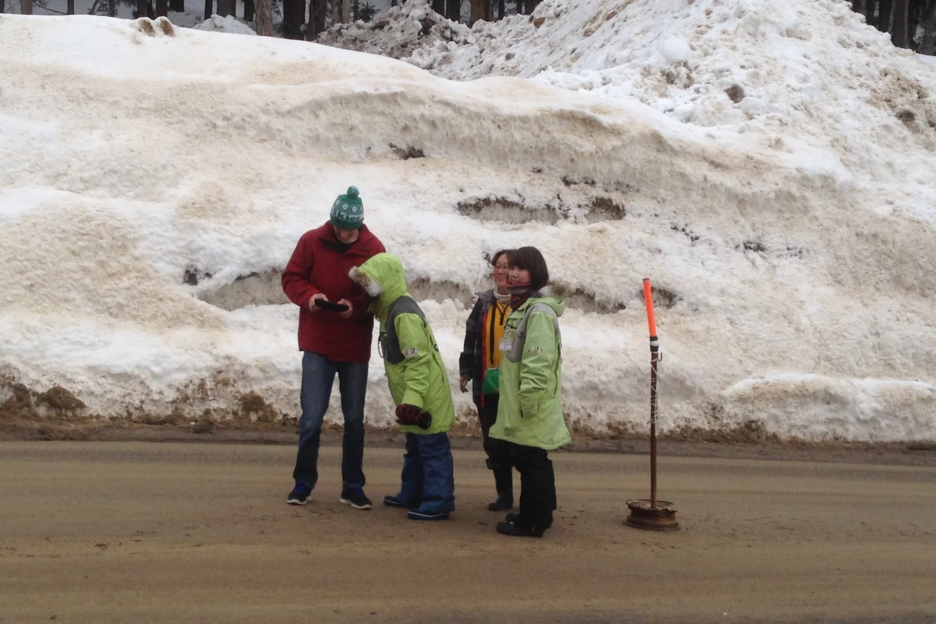 Charlie towers over Japanese women while asking for directions