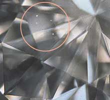 This diamond would probably receive a VVS1 or 2 rating based on the size and location of the inclusions (circled in the photo).
