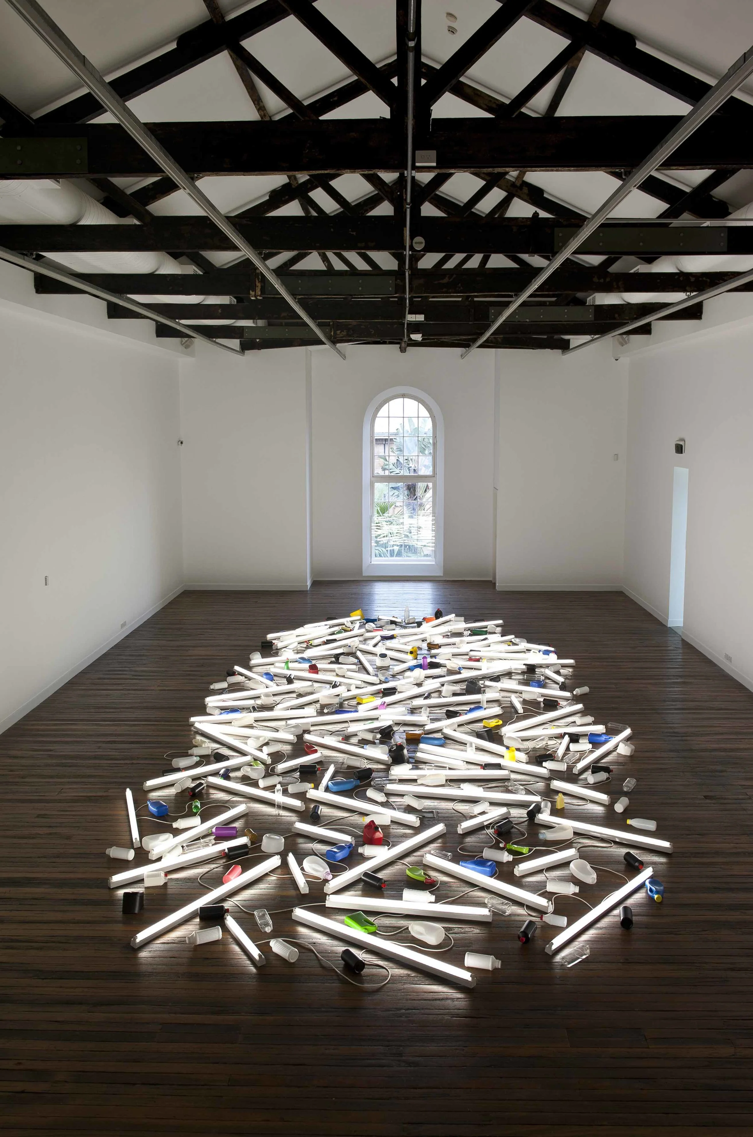 Bill Culbert in January this year at NAS Gallery. Image caption is Bill Culbert Pacific Flotsam (2007) installation view, NAS Gallery January 2015 Photo: Peter Morgan.