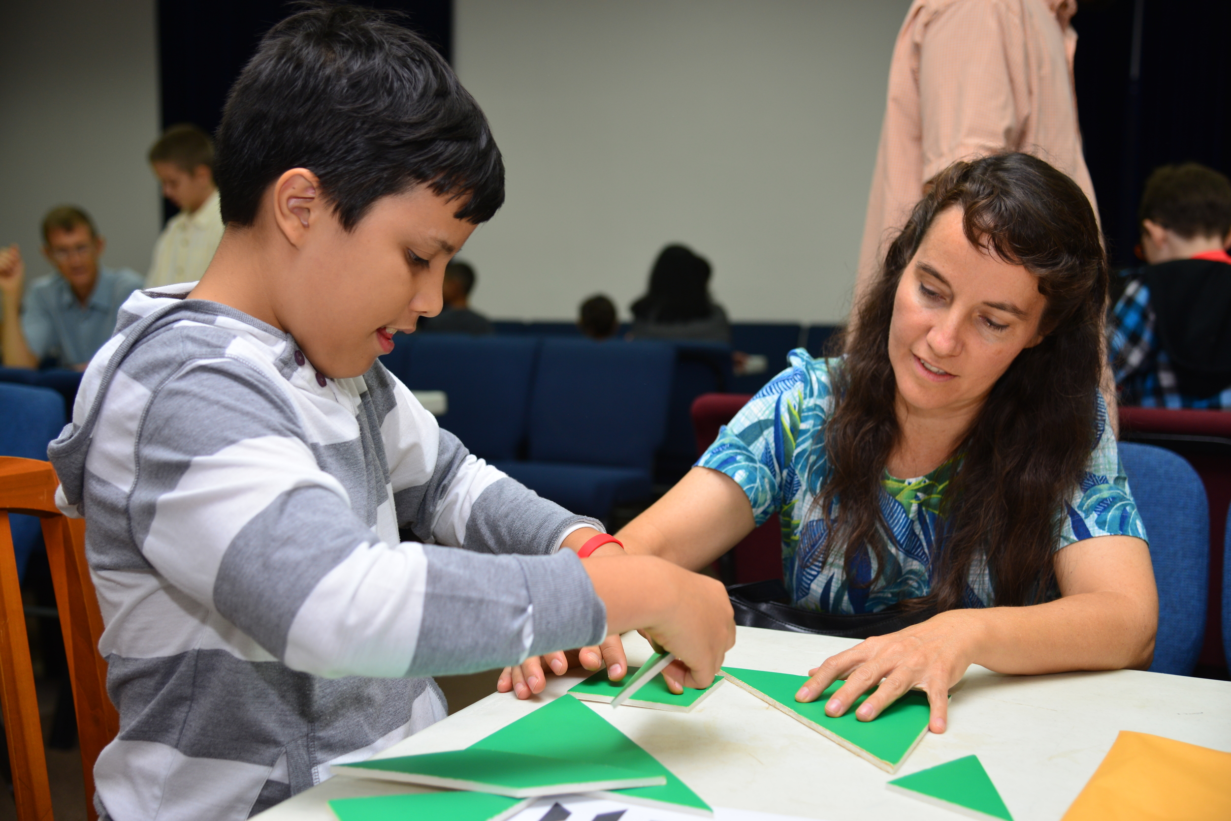 Jonathan solves the tangram puzzles with his mother Collette Supit. 
