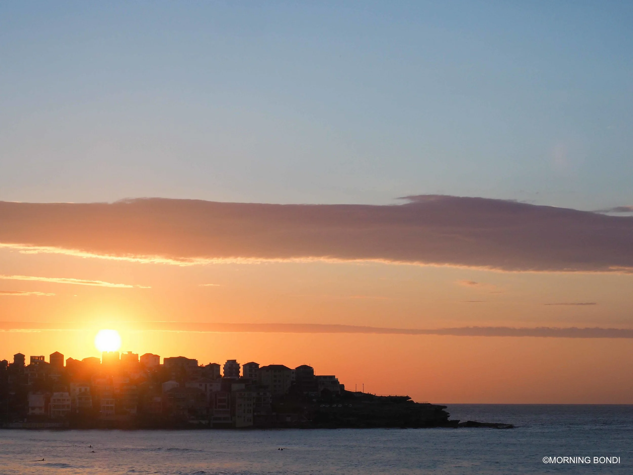 6am, the sun is rising above the tallest building in North Bondi