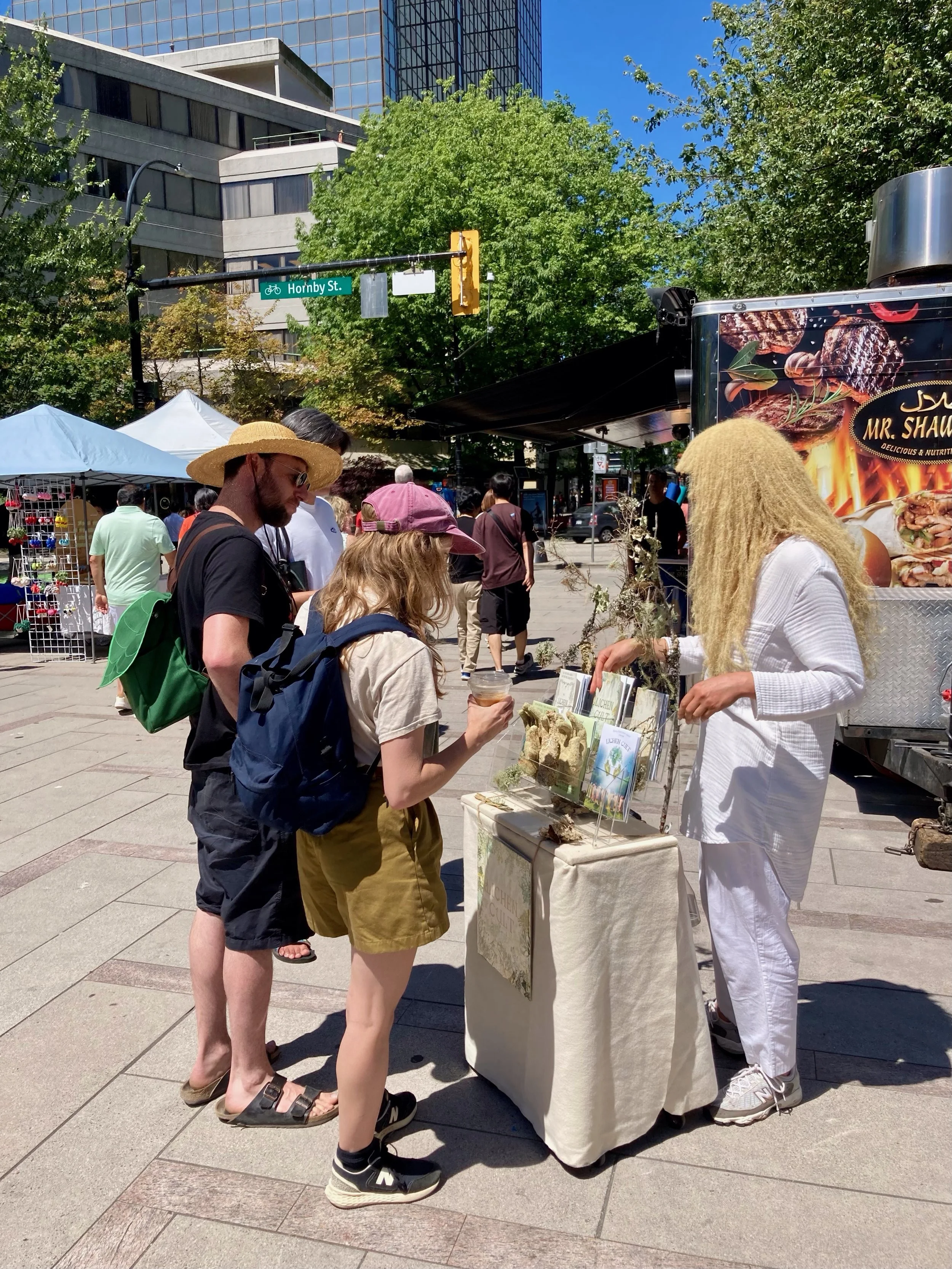Lichen Cult Street Performance, Vancouver, 2024. Sharing educational information and philosophical insights into the world of lichens while handing out Lichen Cult propaganda to passers by.