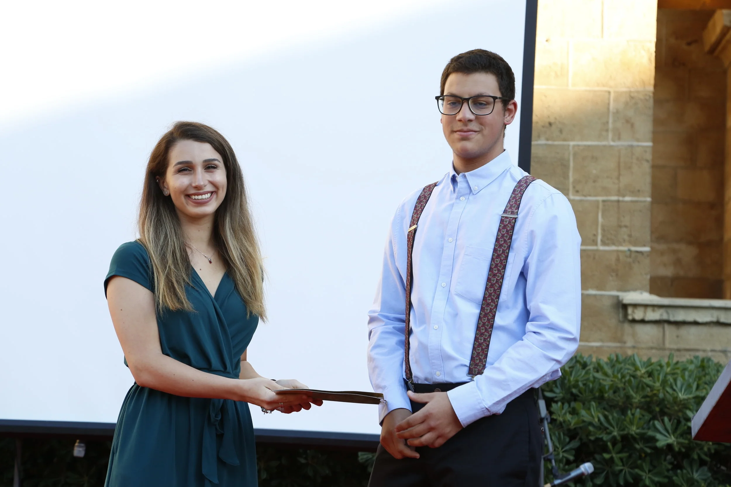 Farah accepting the award from Usama al-Khalidi’s grandson, Ali-Usama Zreik.