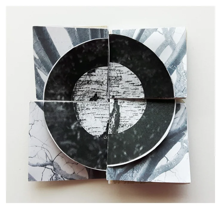 Front of book cut to a circle so paper behind is partially shown.