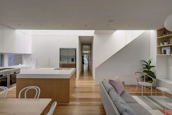 Monolithic shapes look great in large spaces. Make use of the island for storage if you don't need the seating.