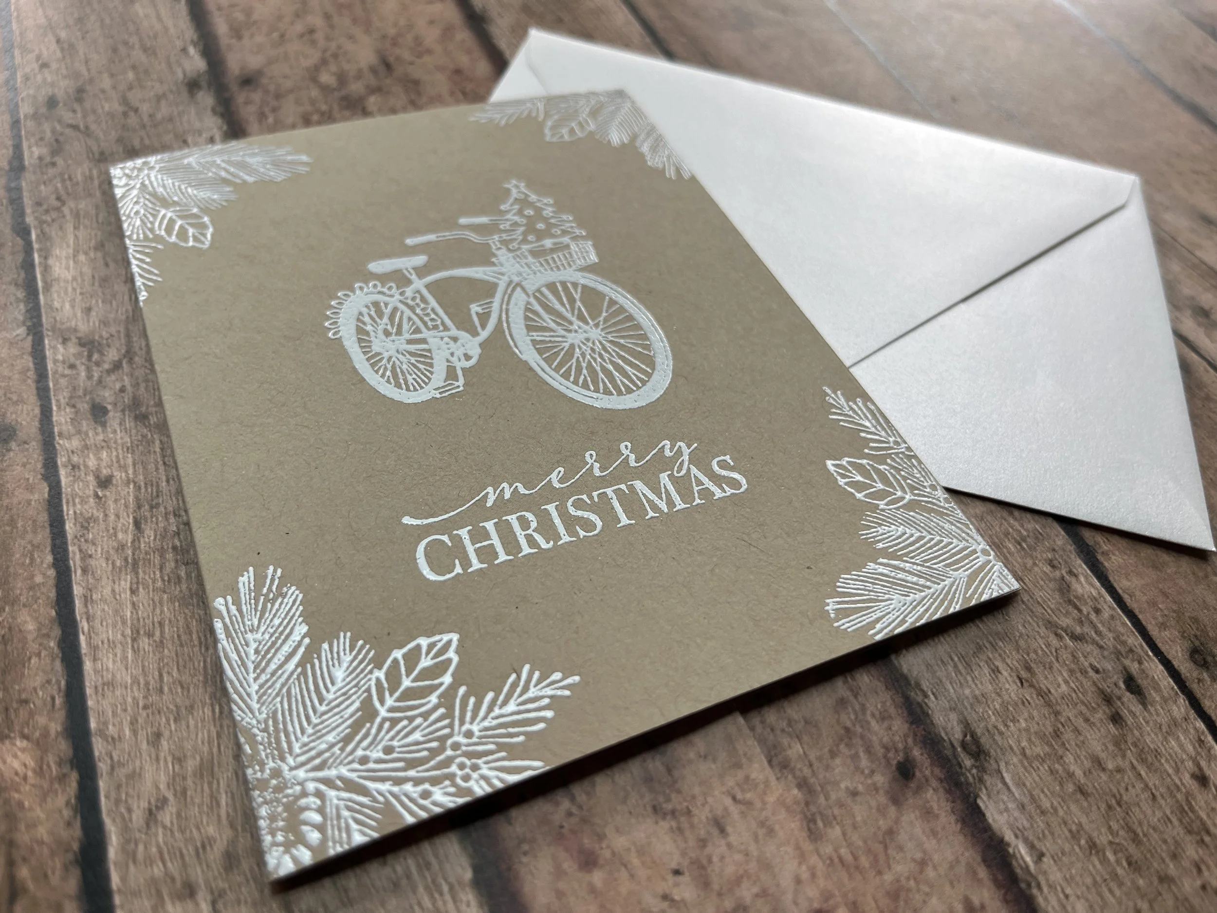 https://www.onegreenlove.com/holiday/festive bicycle merry christmas card winter white ink on kraft cardstock