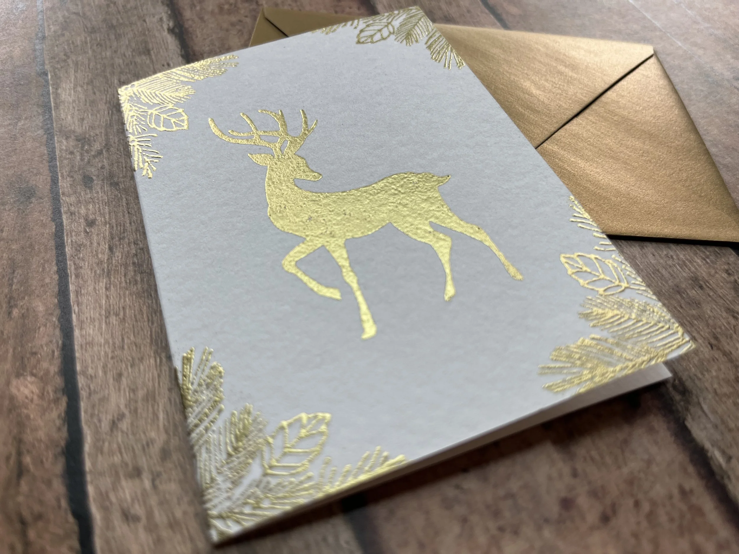 https://www.onegreenlove.com/holiday/the graceful reindeer shimmer gold on white cardstock with matching envelope