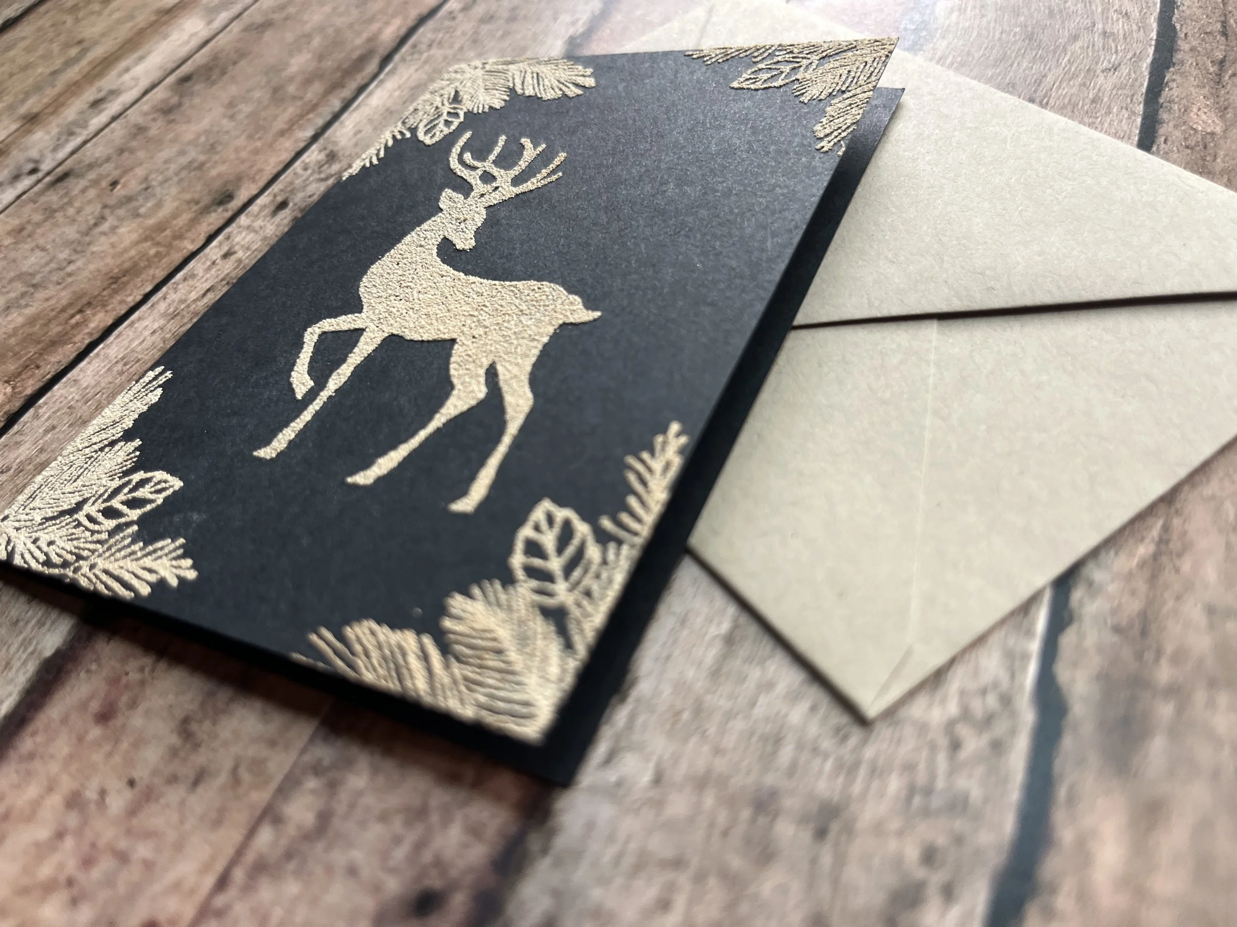 https://www.onegreenlove.com/holiday/the graceful reindeer khaki on black cardstock with matching envelope