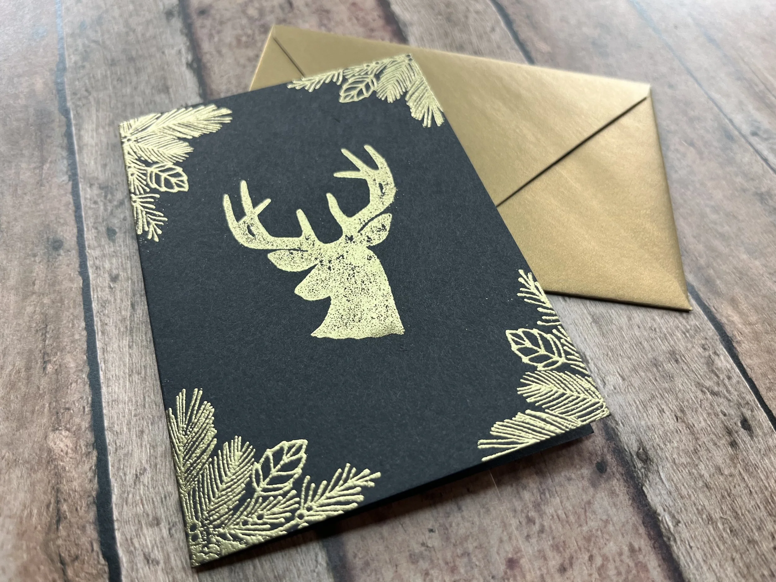https://www.onegreenlove.com/holiday/the noble reindeer handmade christmas card shimmer gold ink on black cardstock with matching envelope