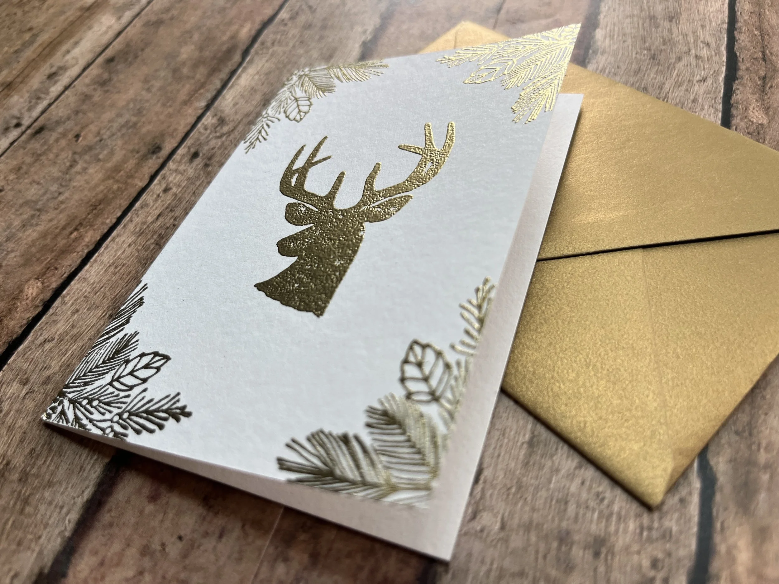 https://www.onegreenlove.com/holiday/the noble reindeer shimmer gold on white cardstock with matching envelope