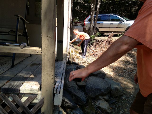 Above: My son and husband measuring a piece of trim that needed to be replaced in 2014. Below: My husband and brother-in-law replacing the roof while my son and niece inspect their work in 2006.