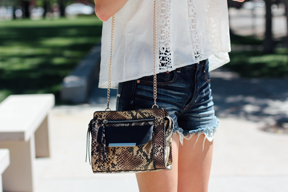 JustFab handbag, American Eagle shorts, and Forever 21 off-the-shoulder blouse via truelane.png