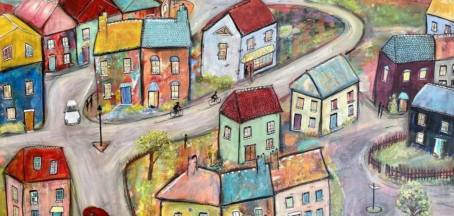 Feels Like Home to Me, acrylic on canvas. A village of colourful houses around a winding road, with cyclists, a small car and figures walking.
