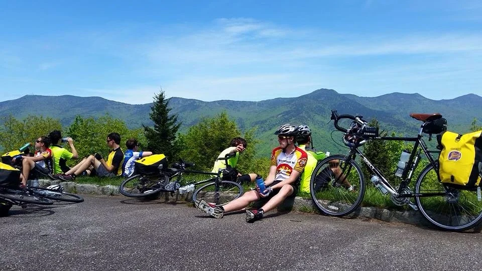 Who needs a camp chair when you can do the lean? Taking a break along the Blueridge Parkway. Mt Mitchell looms in the distant background. 