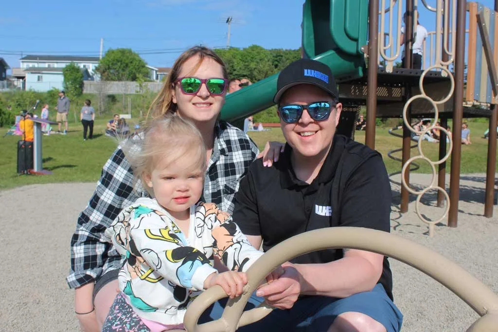  Little Violet Humby enjoys the new playground equipment with parents Elizabeth and Damien. Mark Squibb photo 