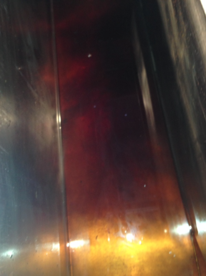 Sap boiling in the back pan, just starting to get reddish.