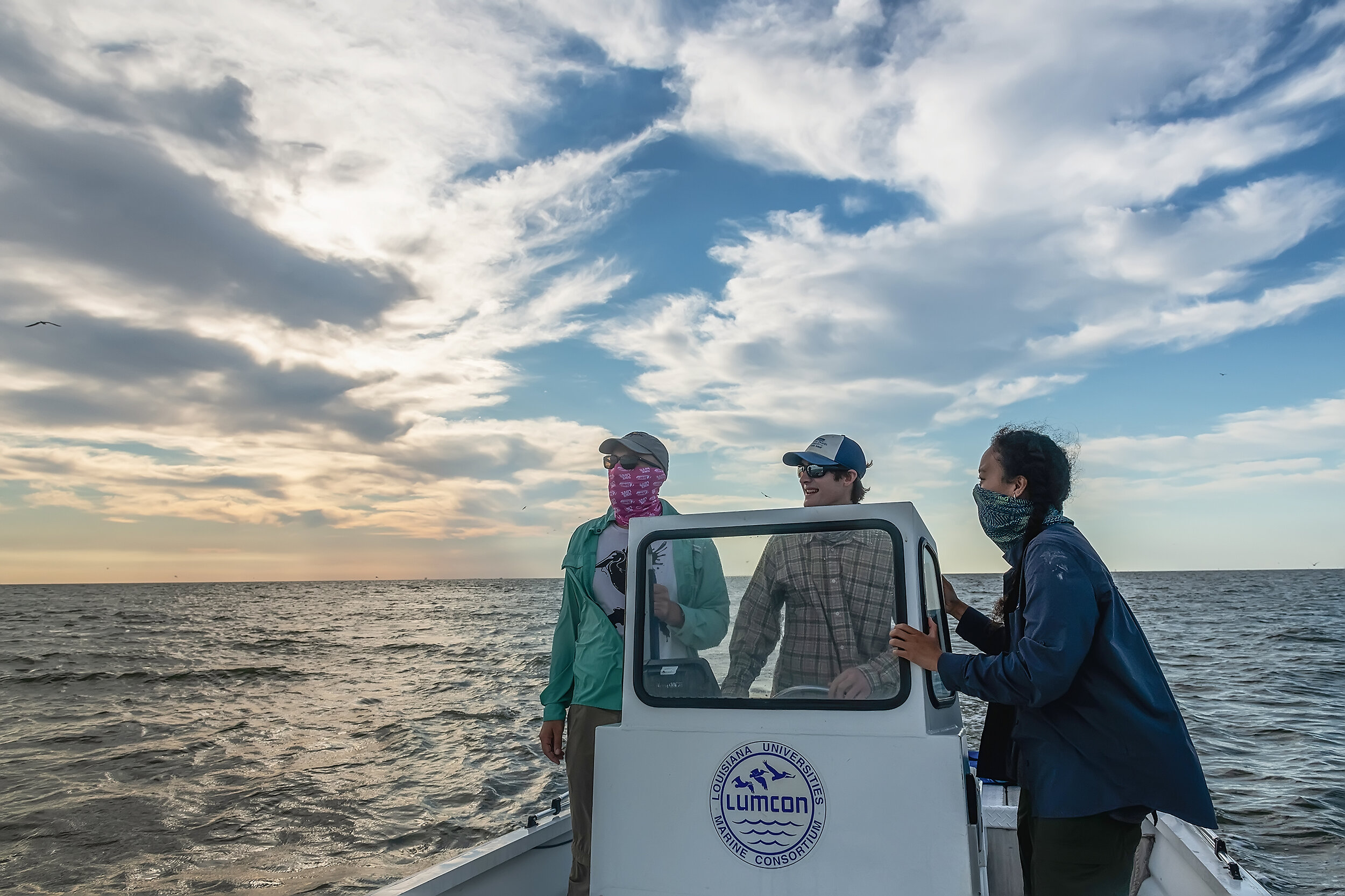 Juita Martinez and her two field assistants Eric Tobin and Mason Harris head out early morning on the Gulf of Mexico to check her study cameras and to band and weigh some of the brown pelicans on the barrier islands of Louisiana. She is studying the
