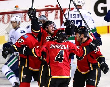 The Calgary Flames celebrate after Matt Stajan scores, taking the Flames into the lead over the Vancouver Canucks. Photo credit: Calgary Sun