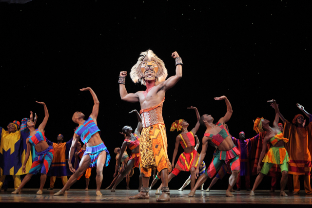 Aaron Nelson (centre) leads the company of "The Lion King" in the role of Simba. Photo by Broadway Across Canada.