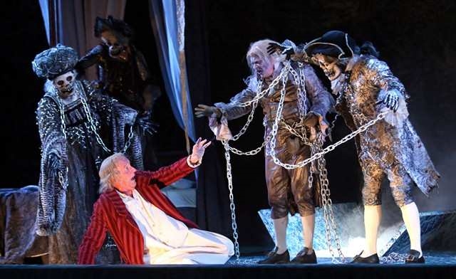 Ebenezer Scrooge, played by Stephen Hair (front) is visited by Jacob Marley's crew on Christmas eve. Photo courtesy of the Calgary Herald. 